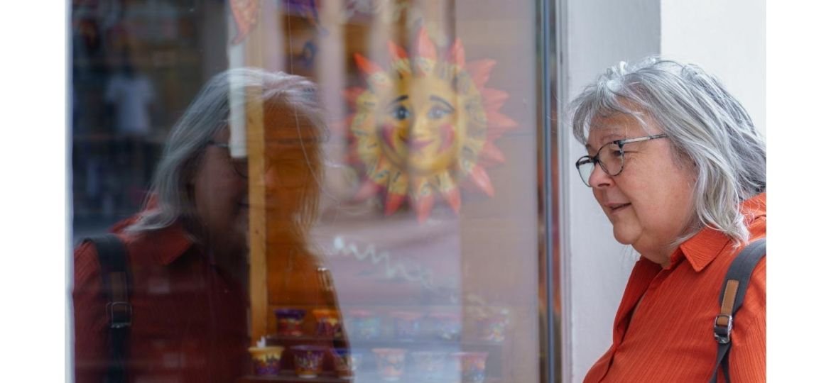 Older woman looking in a window